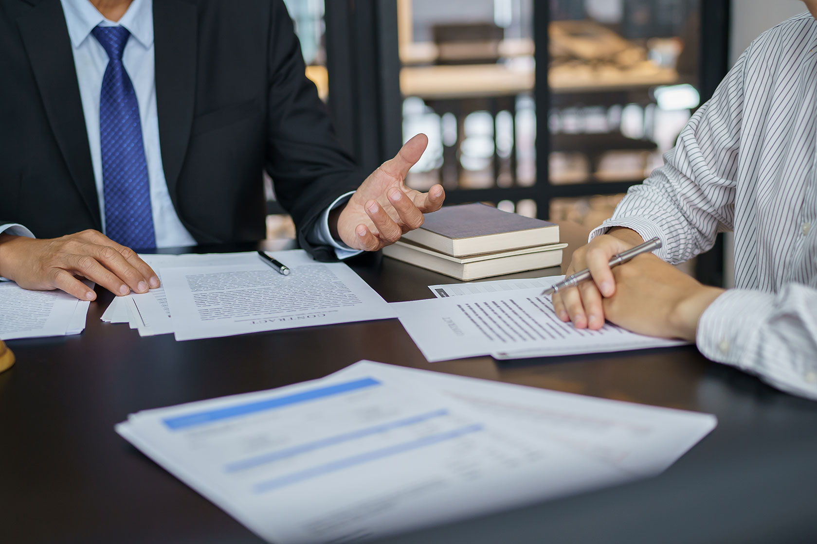 people at table over legal documents